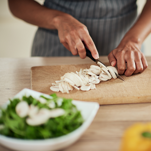 Person chopping mushrooms