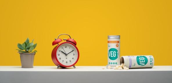 VEG 1 pots next to an alarm clock and plant