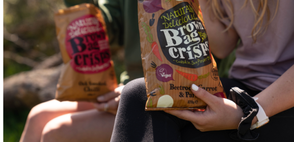 Naturally Delicious Brown Bag Veggie Crisp packet with Vegan Trademark displayed