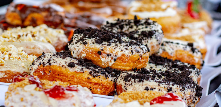 Variety of vegan donuts displayed on a stand at the Stockport Vegan Festival