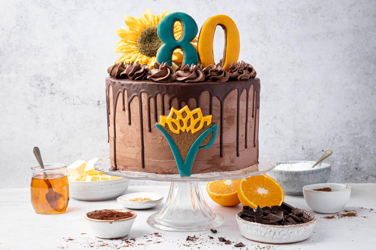 80th anniversary cake surrounded by ingredients