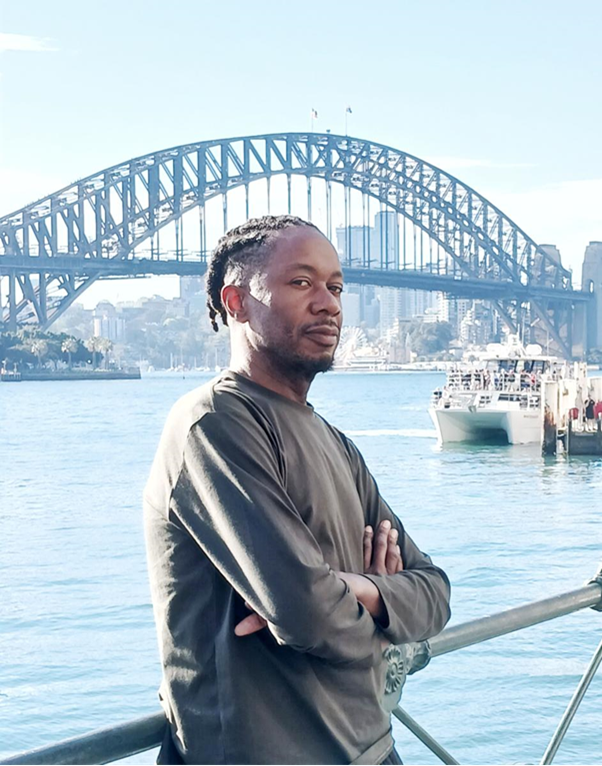 Photograph of Akil Goin with a bridge in the background