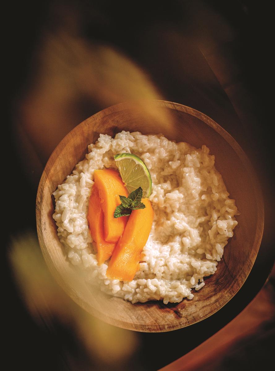 Vegan coconut rice pudding garnished with mango, lime and mint 