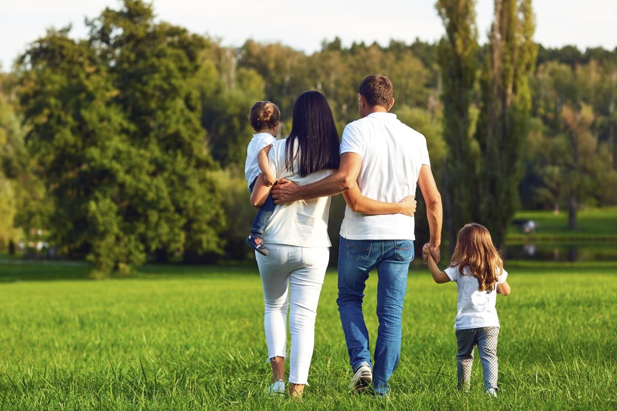 Happy family with children walking in the park.