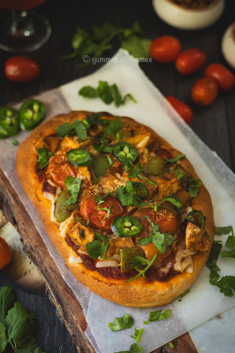 Tikka Masala Naan Pizza served with garnish